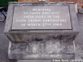 Outdoor granite block is lettered as a memorial to those who died in a 1964 earthquake.