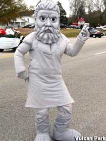 Person outdoors, wearing a costume and mask of a gray, bearded man with large, angry eyes.