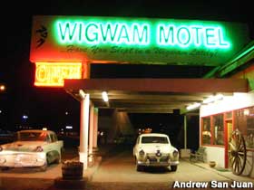 Night view of Wigwam Motel office entrance.