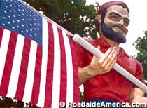 Muffler Man with flag.