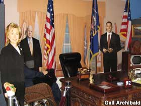 Oval office scene with cardboard candidates.