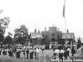 1930s view of Candy Castle with a ceremony underway that appears to involve flags, saluting and little grave marker cros