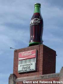 Giant Coca-Cola Bottle on top of bottling plant.