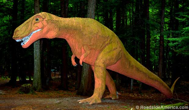 T.rex lurks in the dark forest at Dinosaur Gardens Prehistoric Zoo, Ossineke, Michigan.