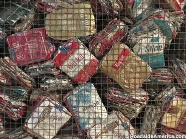 Mesh bin holds 108,000 cigarette packs saved by a delusional patient.