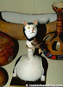 Gourd Cat plays a fiddle.
