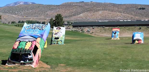 Antique cars as golf ball targets. The Nevada driving range is a tribute to Cadillac Ranch in Texas.