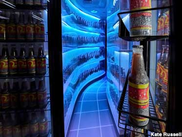 Beverage cooler portal warps space-time and chilled bottles.