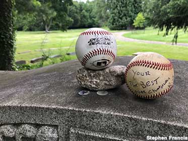 Baseball offerings at the grave of Ray Chapman.