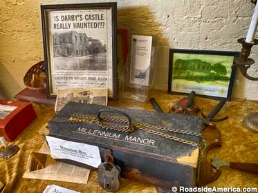 Donation box and newspaper clipping that describes the Manor in the 1980s.