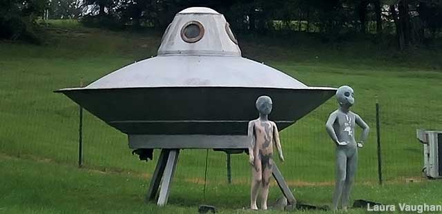 Yard art aliens and saucer.