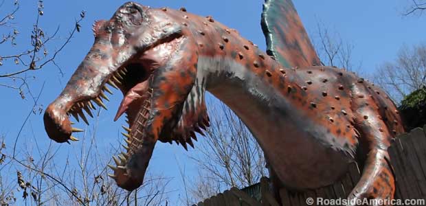 Dagger-toothed Spinosaurus lurches over a fence at Backyard Terrors.