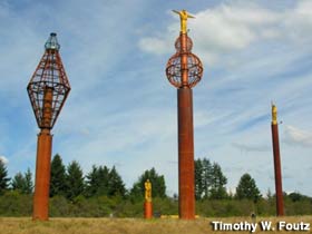Copper statues on pylons.