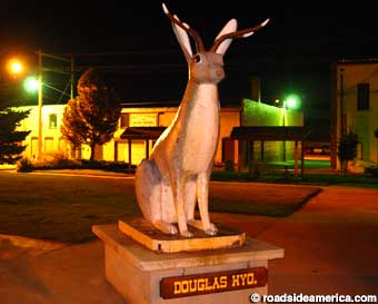 Town's main Jackalope statue at night.