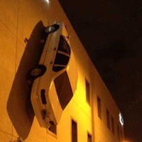 Car Stuck on Side of Building