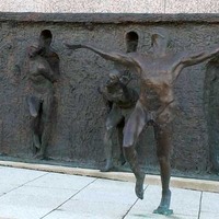 Bronze Bodies Emerge From Bronze Wall
