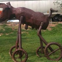 Statue of a Pig on Wheels