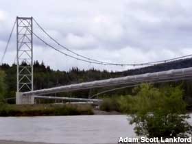 Oil pipeline has its own suspension bridge across a river.