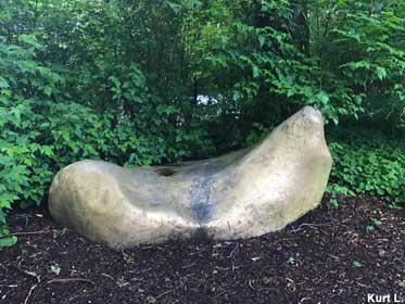 Outdoor boulder painted gold.