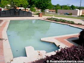 An outdoor water-filled pool shaped like the state of Alabama.