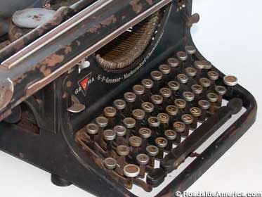 Close-up of the keyboard on an old, black metal typewriter.