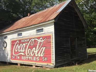Old sign painted on the side of a barn: 