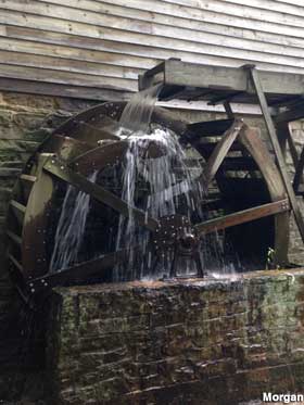 Overshot mill water wheel spinning with water.