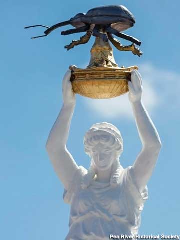 Close-up of today's monument, with its mega-weevil hoisted above the Greek lady's head.