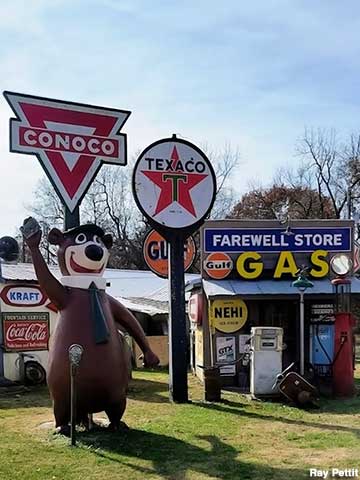Gas signs and Yogi Bear statue.