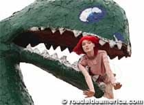 Dinosaur chomping a woman mannequin.
