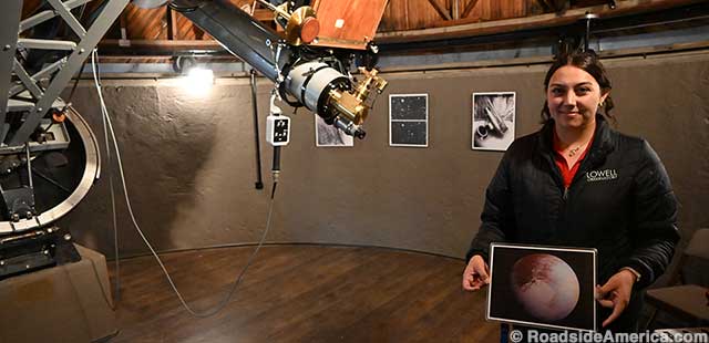 Staffer holds photo of Observatory's favorite planet: not Mars, but Pluto.