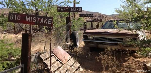 Derelict car and signs.
