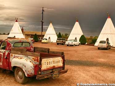 Beaten up Studebaker pickup and teepees.