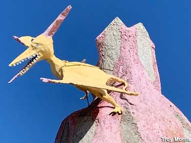 Pterodactyl perches on the pink lava volcano.