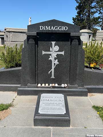 DiMaggio grave with baseball and bat offerings.