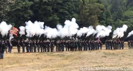 Union troops fire their rifles in unison.