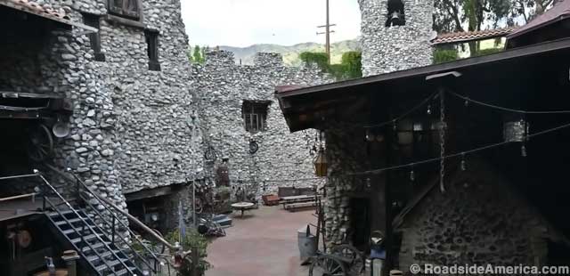 Castle courtyard showcases its walls of river rock.