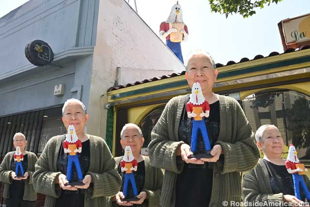 Amy Inouye (X5) holds souvenir statues while the real Boy roosts overhead.