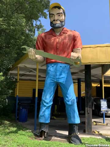 Muffler Man with ball cap and wrench.