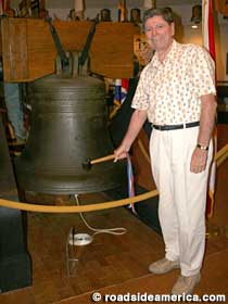 Curator Peter Diaz rings the Liberty Bell with a rubber mallet.