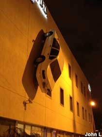 Car on side of building.