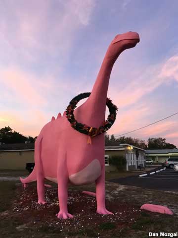Pink dinosaur in holiday mood.