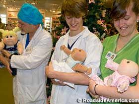 Doctors and nurses care for newborns.