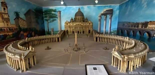 Tiny Vatican model fills a room with wall murals of Rome.