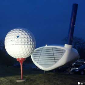 Giant golf ball and club.