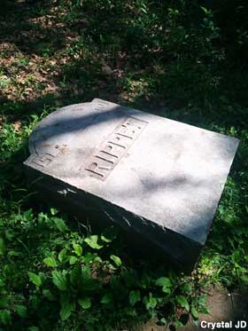 Overturned tombstone.
