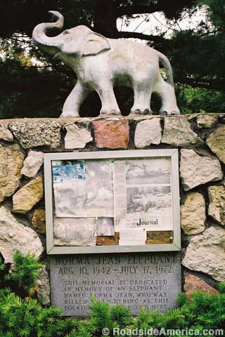 Marker and original statue at the grave of the elephant, Norma Jean.