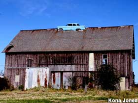 Car in barn roof.