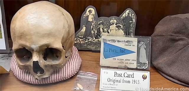 Skull of an unidentified Belle victim and a vintage souvenir postcard.