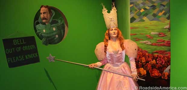 Glinda the Good Witch wears skyscraper crown, hefts wand that seems suited for witch stick-fighting.